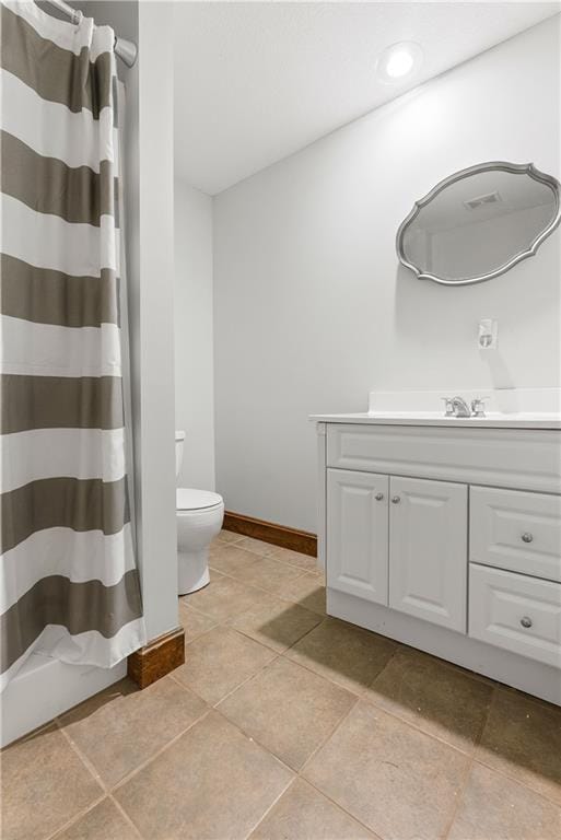 full bath with a shower with curtain, toilet, tile patterned flooring, baseboards, and vanity