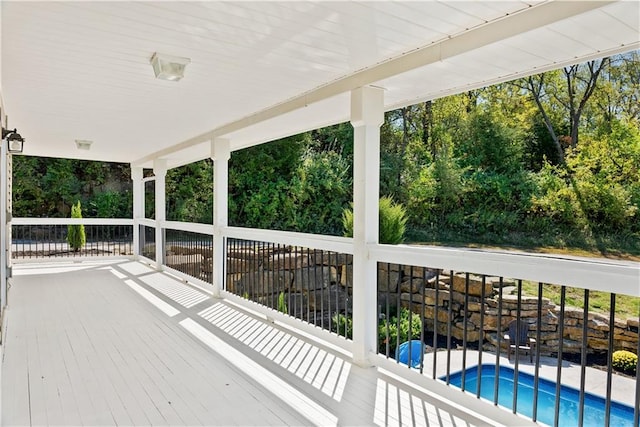 wooden deck featuring an outdoor pool