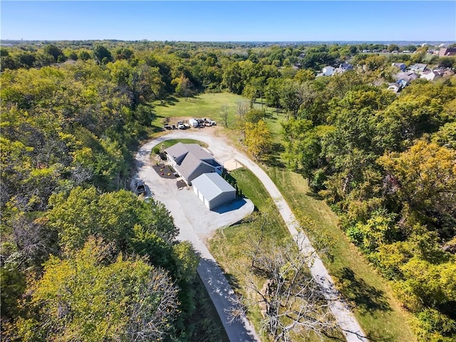 bird's eye view featuring a wooded view