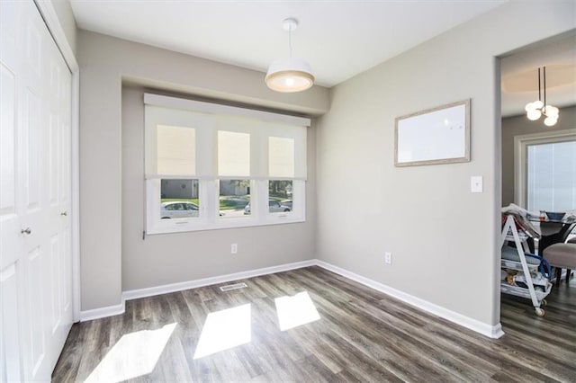 unfurnished room with dark hardwood / wood-style flooring