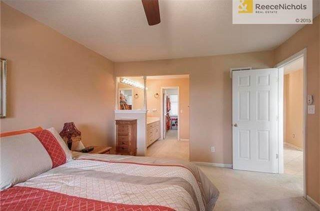 carpeted bedroom featuring ceiling fan and connected bathroom