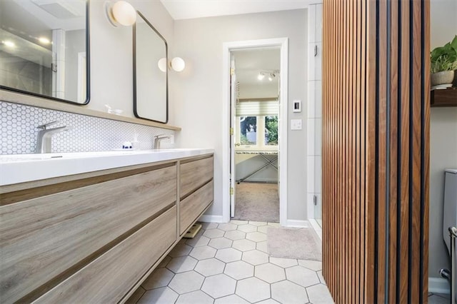 bathroom with decorative backsplash, vanity, tile patterned floors, and a shower with shower door