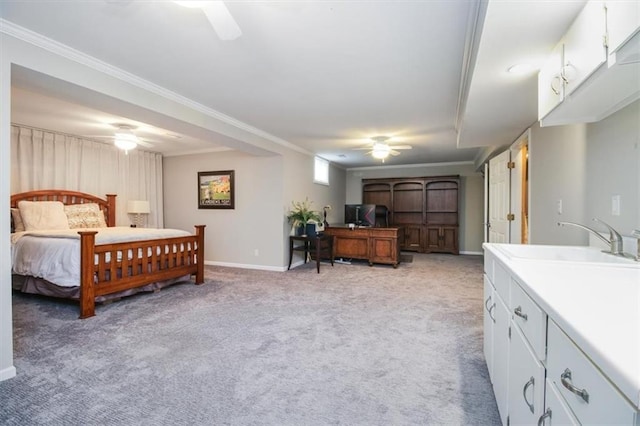 bedroom with ceiling fan, crown molding, sink, and light carpet