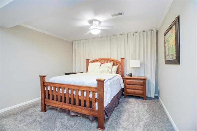 carpeted bedroom with ceiling fan and ornamental molding