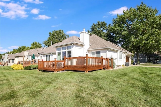 rear view of house featuring a deck, a yard, and central air condition unit