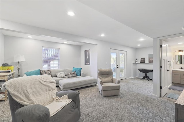 living room featuring carpet flooring, french doors, and a healthy amount of sunlight