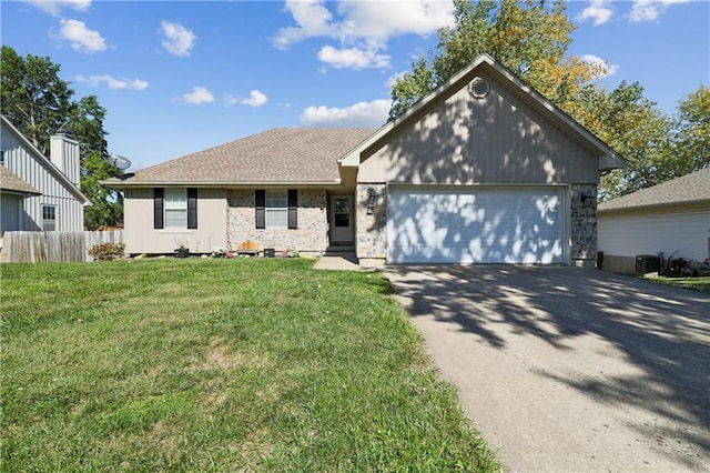 ranch-style home with a front yard and a garage