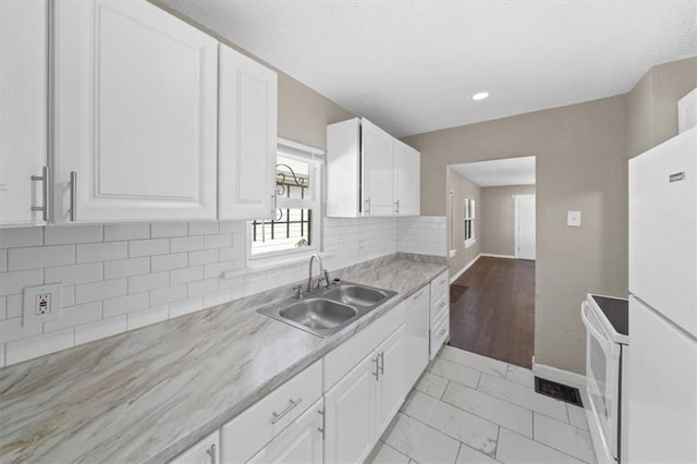 kitchen featuring white cabinets, light hardwood / wood-style flooring, sink, and white appliances