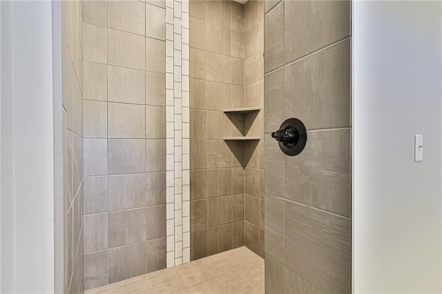 bathroom with a tile shower