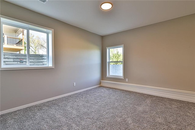 spare room with a healthy amount of sunlight and carpet flooring