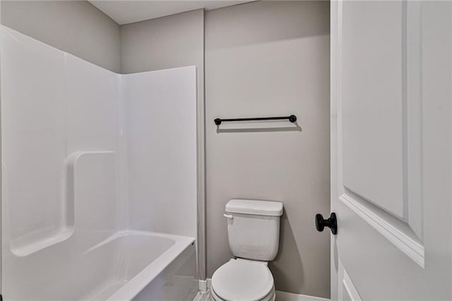 bathroom featuring washtub / shower combination and toilet