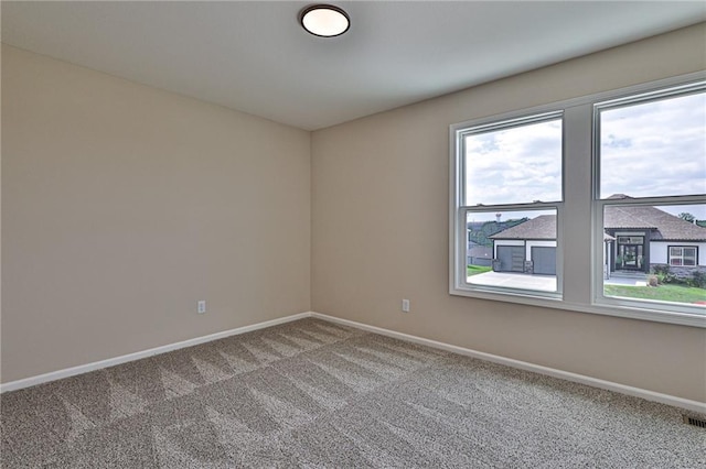 carpeted empty room with baseboards and visible vents