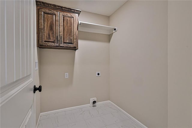 laundry room featuring baseboards, marble finish floor, cabinet space, and electric dryer hookup