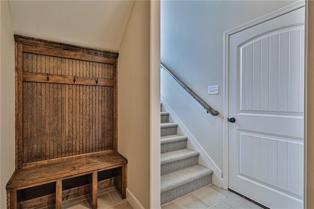 mudroom featuring baseboards and a textured ceiling