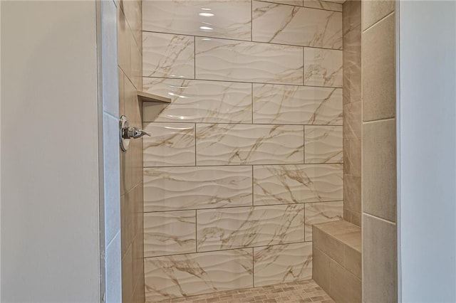 bathroom with a tile shower