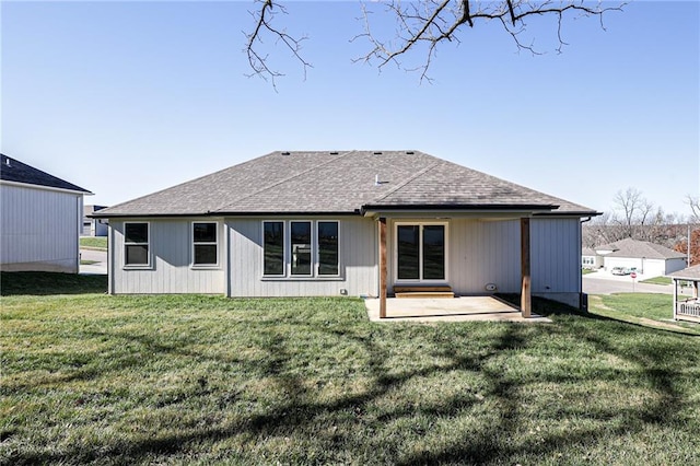 back of property featuring a lawn and a patio