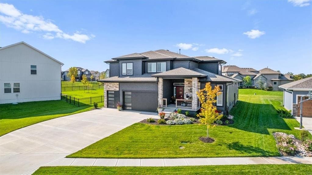 view of front of home featuring a garage and a front lawn