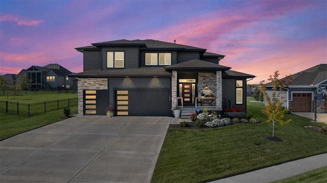 view of front of property with a yard and a garage