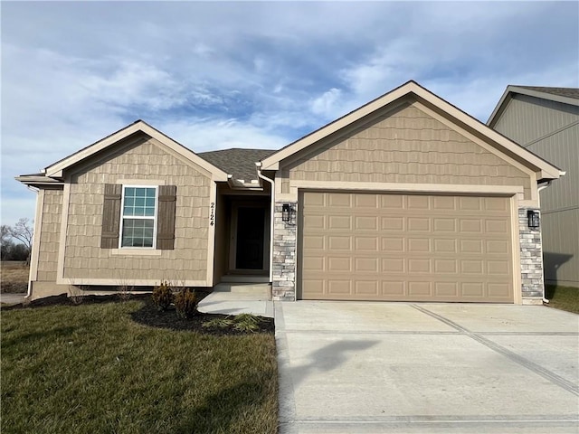 view of front of property featuring a garage and a front lawn