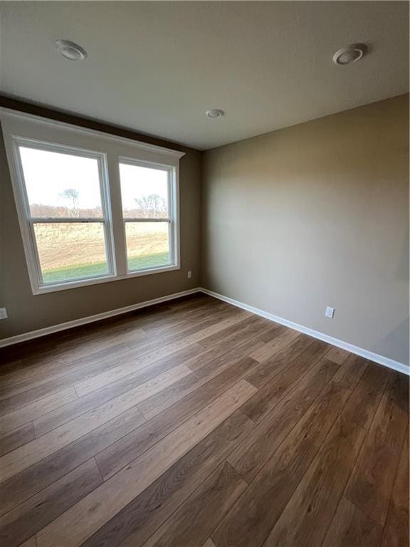 spare room with wood-type flooring