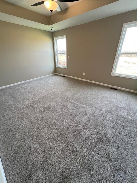 carpeted empty room featuring ceiling fan