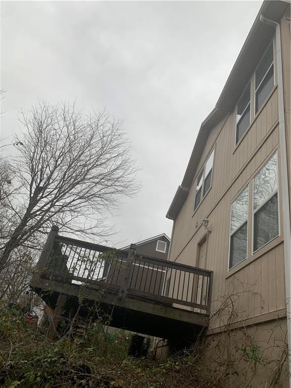 view of side of property featuring a wooden deck