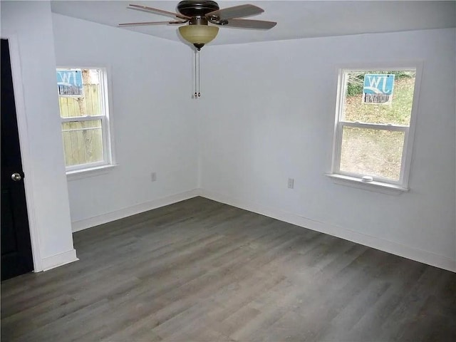 empty room with ceiling fan, vaulted ceiling, and dark hardwood / wood-style flooring