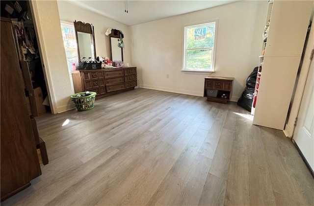 bedroom with light hardwood / wood-style flooring and a closet