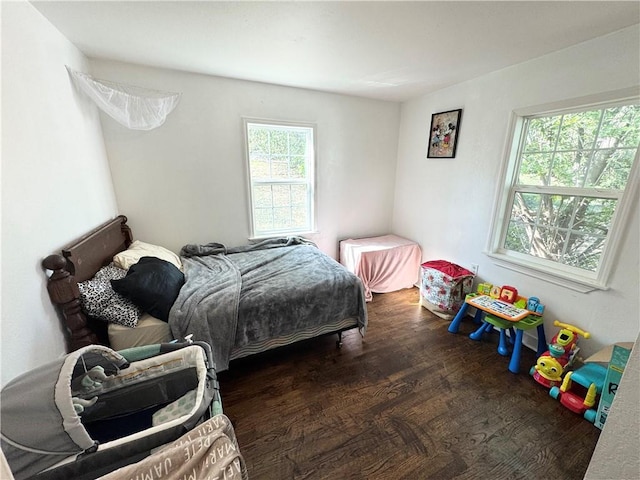 bedroom featuring dark hardwood / wood-style floors and multiple windows