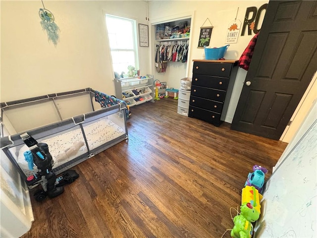 bedroom featuring a closet and dark hardwood / wood-style flooring