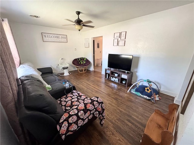 living room with hardwood / wood-style flooring and ceiling fan