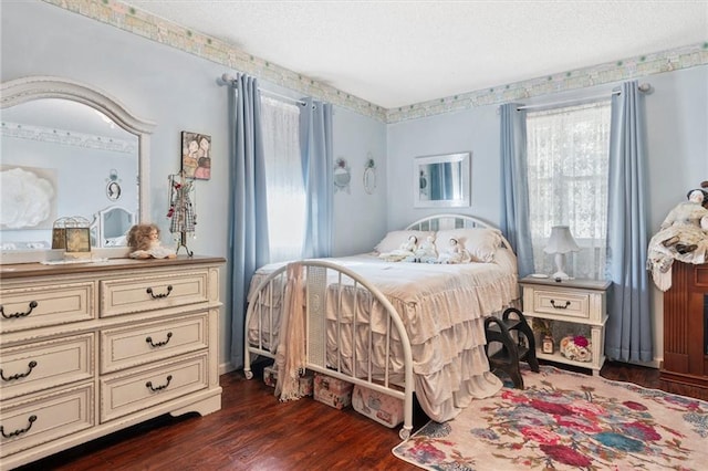 bedroom with dark hardwood / wood-style flooring