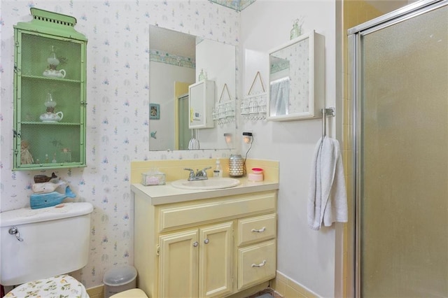 bathroom featuring vanity, a shower with shower door, and toilet