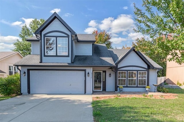 view of front of house with a front yard and a garage