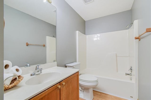 full bathroom featuring vanity, bathtub / shower combination, toilet, and hardwood / wood-style flooring