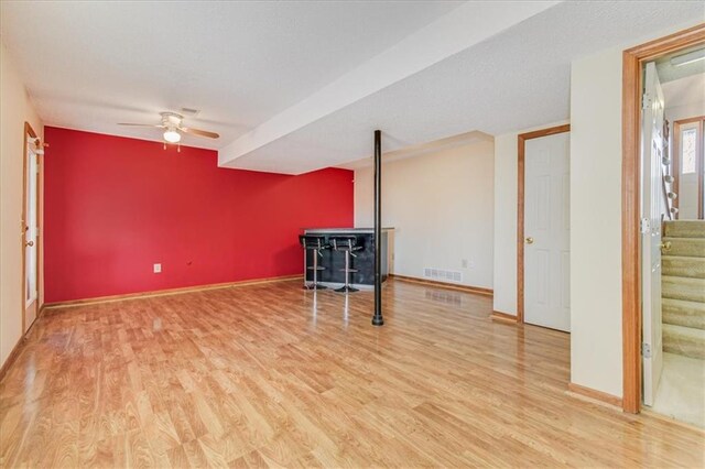 interior space with ceiling fan and wood-type flooring