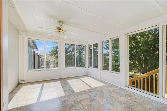 unfurnished sunroom featuring ceiling fan