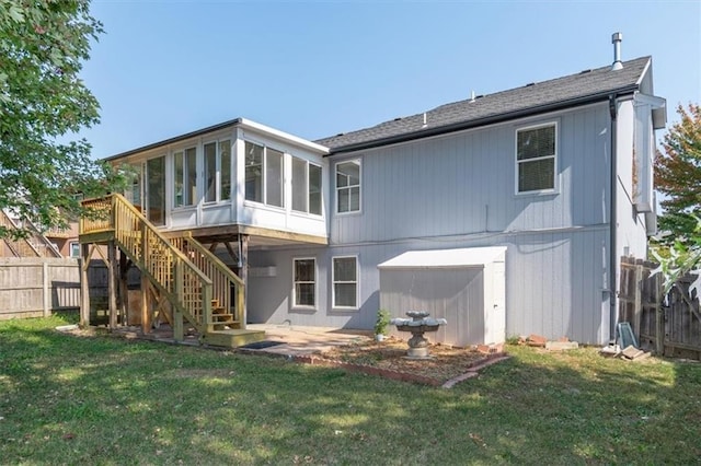 back of house with a yard, a sunroom, and a patio