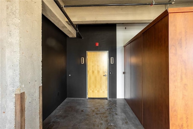 hall featuring concrete flooring