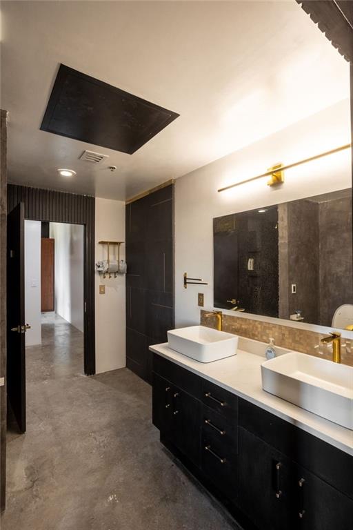 bathroom with vanity and concrete floors