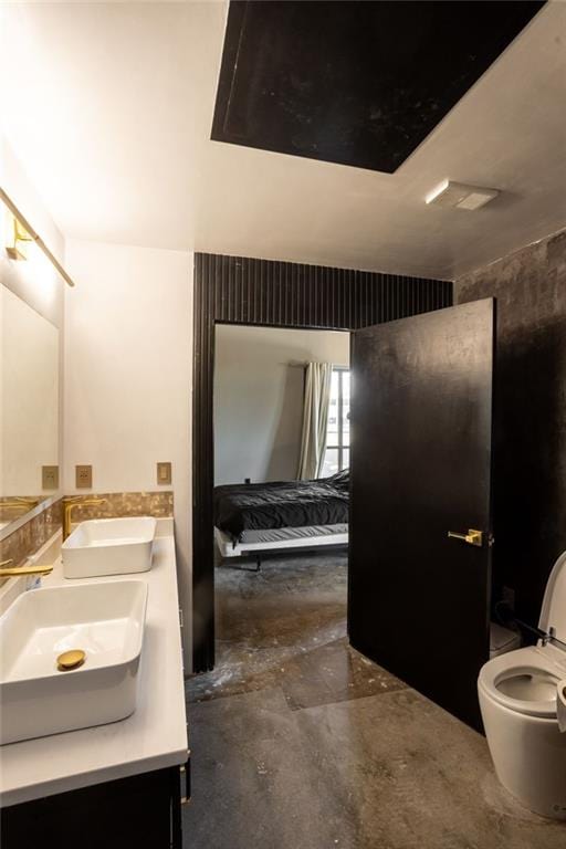 bathroom featuring vanity, toilet, and concrete floors