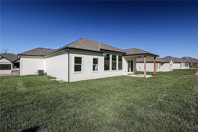 back of house with central AC unit, a yard, and a patio area