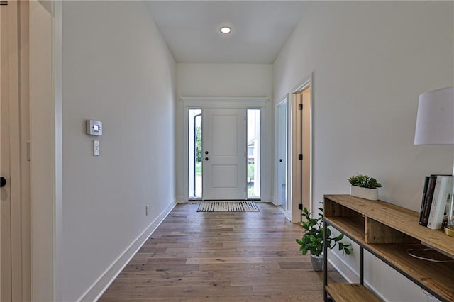 entryway with recessed lighting, wood finished floors, and baseboards