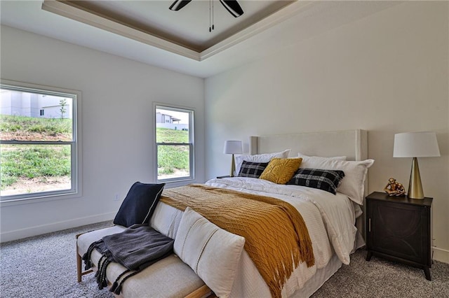bedroom with carpet flooring, a ceiling fan, a raised ceiling, and baseboards