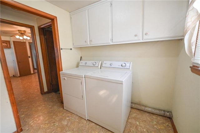 washroom featuring washing machine and dryer, ceiling fan, and cabinets