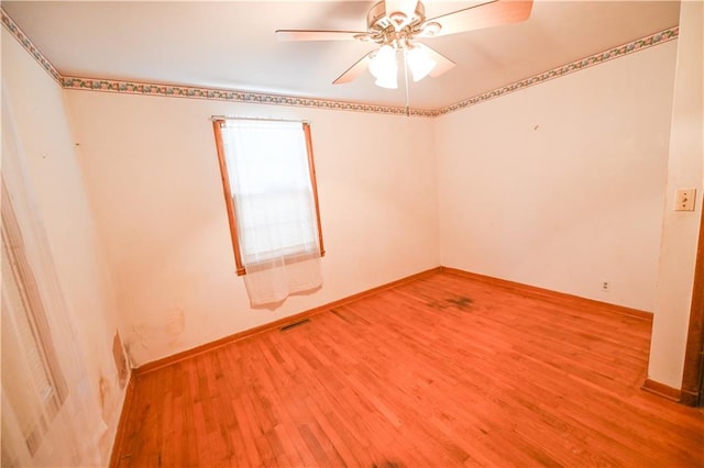 unfurnished room with ceiling fan and hardwood / wood-style floors