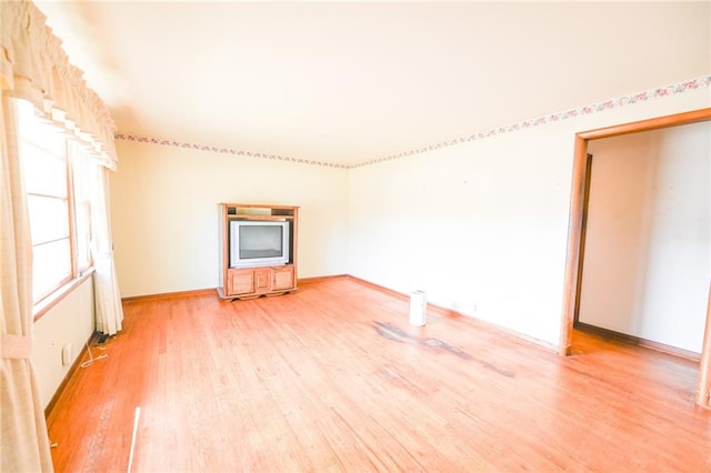 unfurnished living room featuring hardwood / wood-style flooring