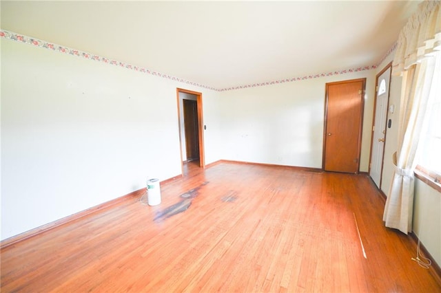 unfurnished room with light hardwood / wood-style flooring