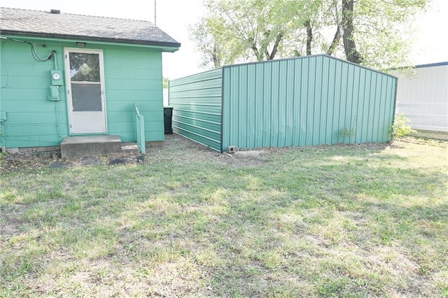 view of outbuilding featuring a yard