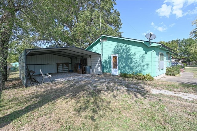 exterior space featuring a yard and a carport